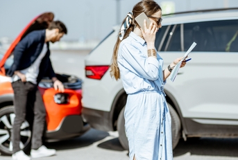 woman calling road assistance after the car collision