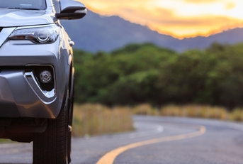 silver SUV car parking on the asphalt road