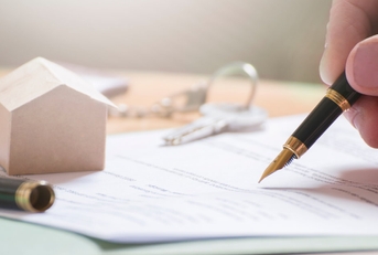 man signing documents with fountain pen