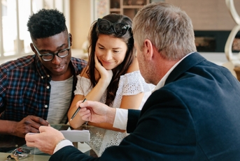 real estate agent explaining agreement to a couple