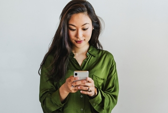 Smiling woman looking at phone