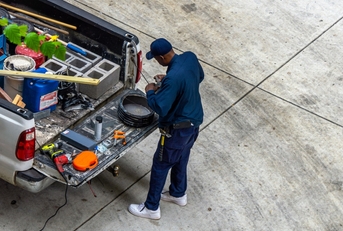 An adult man offering home services with a pickup truck
