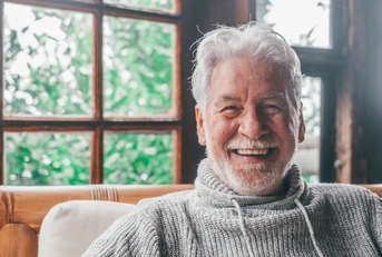 old man smiling and looking at the camera