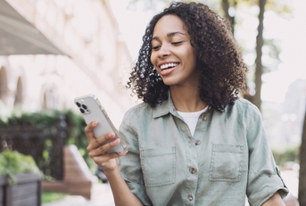 Woman smiling and looking at phone