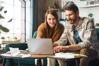 couple doing accounting using laptop