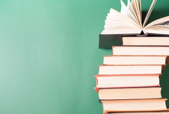 hardback books on wooden table