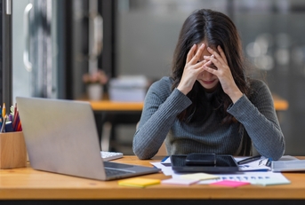 tired young woman working on documents