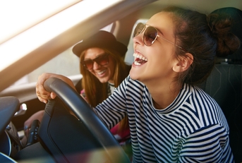 Two women in a car laughing