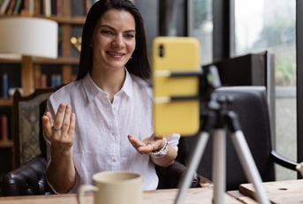 Woman filming herself with a phone