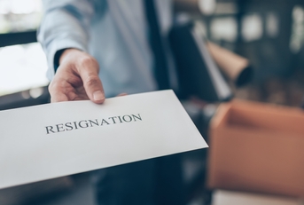 businessman showing resignation letter to employer boss