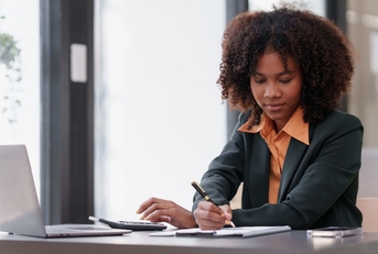 woman working on laptop and doing taxes