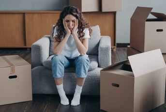 unhappy woman is sad because of relocation