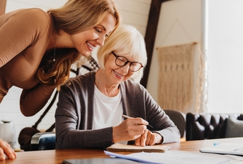 investment advisor consulting with retired woman at home