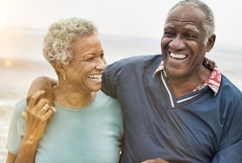 happy african american senior couples trolling at beach