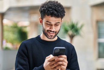 Man looking at phone and smiling