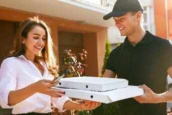 man delivering a pizza to a woman