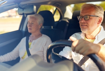 Older couple driving car