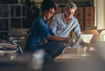 Two people discussing business credit card application