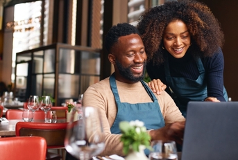 Couple running a business and researching business credit cards and lines of credit