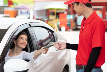 worker receiving money from driver customer