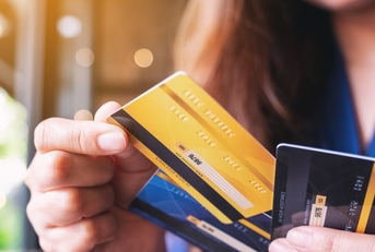 woman choosing credit card to make payment