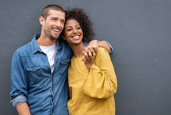 multiethnic couple in love standing and holding hands