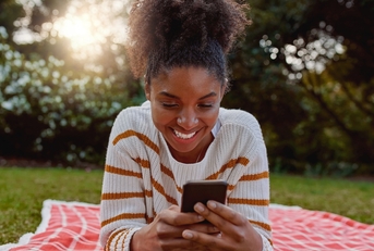 Happy woman looking at phone