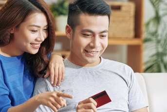 Couple using a credit card