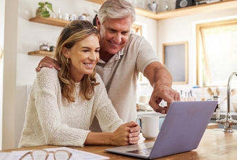 An older couple looking at computer