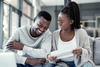 Happy couple working on bills