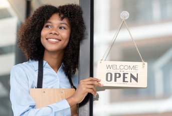 Happy woman holding an open sign