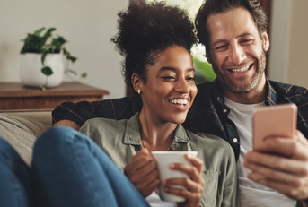 young couple using a cellphone together
