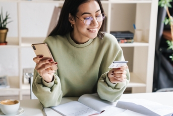 young girl student holding credit card