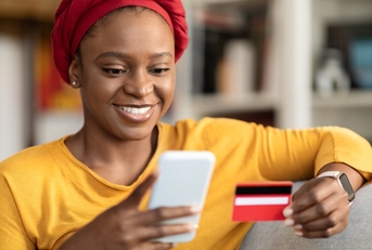 An adult woman using a credit card