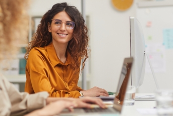 female colleagues interacting while working in office