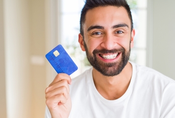 man holding credit card with a happy face
