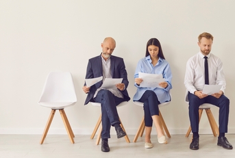 candidates sitting on chairs waiting for job interview