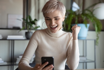 Excited woman with phone