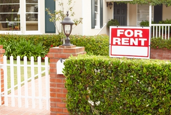 for rent sign in front yard of house in street