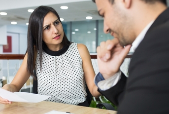 businesswoman in office getting angry over male colleagues