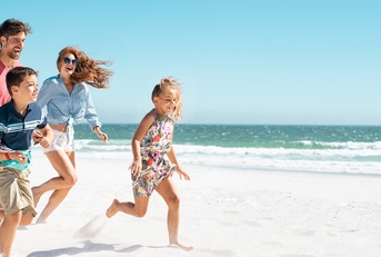 happy family running on beach
