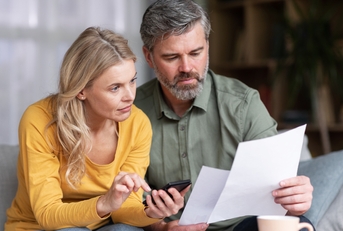 married middle aged couple planning budget together
