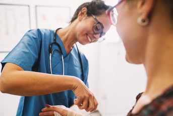 female nurse bandaging at clinic