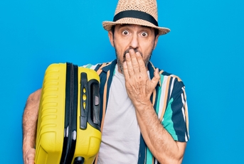 shocked man with luggage