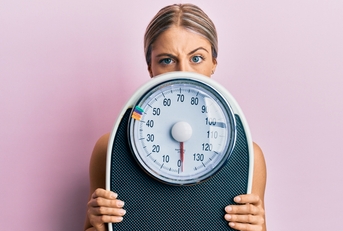woman holding weight machine