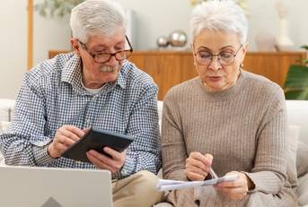 senior couple calculating taxes