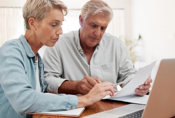 senior couple reviewing bills at home