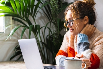 mature woman reading on laptop