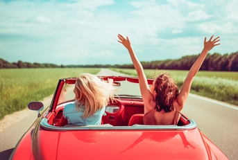 two girls in a red car 