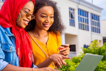 Two young women learning about credit cards
